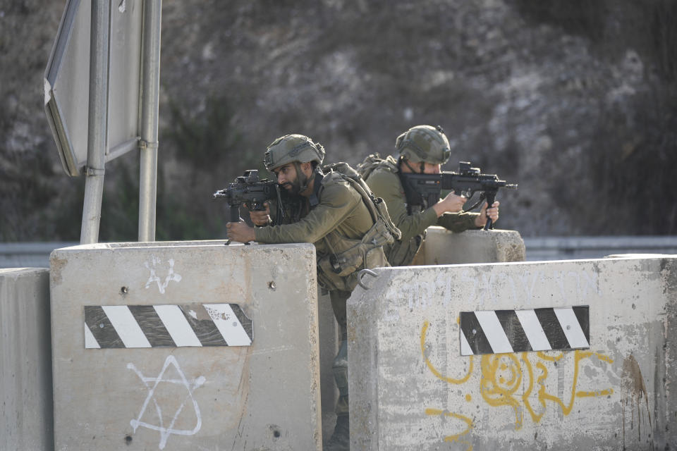 Israeli soldiers take position at a roadblock near the West Bank town of Nablus, Saturday, Sept. 24 2022. Israeli troops on Saturday shot and killed a Palestinian motorist who allegedly tried to ram his car into a group of soldiers patrolling in the occupied West Bank, according to Israeli soldiers and media. (AP Photo/Majdi Mohammed)