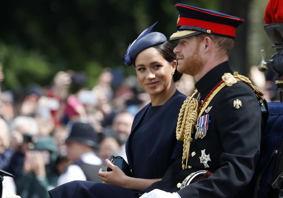 FILE - In this Saturday, June 8, 2019 file photo, Britain's Meghan, the Duchess of Sussex and Prince Harry ride in a carriage to attend the annual Trooping the Colour Ceremony in London. Kensington Palace says on Thursday, June 20 the Duke and Duchess of Sussex will be starting their own foundation to support their charitable endeavors, formally spinning off from the entity Prince Harry and Prince William established together a decade ago. (AP Photo/Frank Augstein, file)