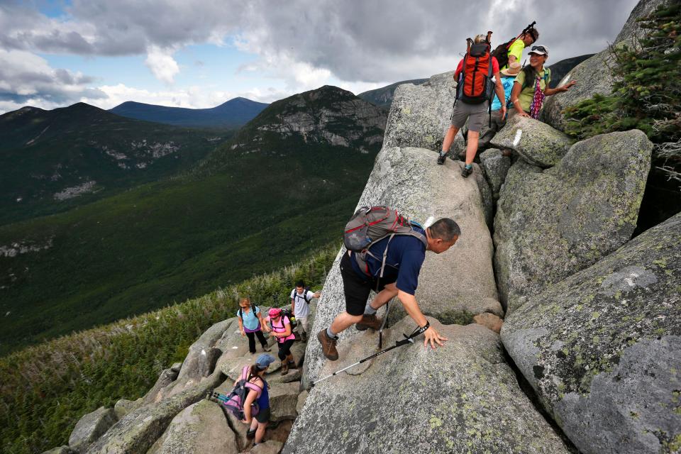 Day-hikers scramble over rocky boulders on the Appalachian Trail below the summit of Mt. Katahdin in Baxter State Park in Maine on Aug. 7, 2015.