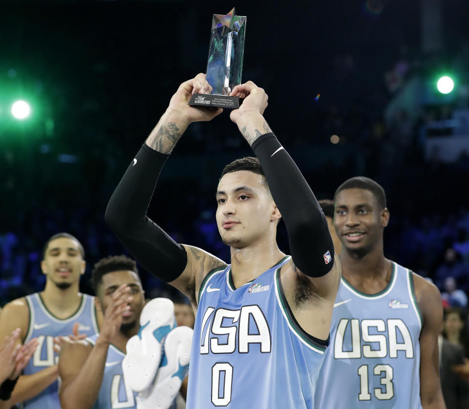 U.S. Team's Kyle Kuzma, of the Los Angeles Lakers holds the MVP trophy after the NBA All-Star Rising Stars basketball game between the World Team and the U.S. Team, Friday, Feb. 15, 2019, in Charlotte, N.C. The U.S. Team won 161-144. (AP Photo/Chuck Burton)