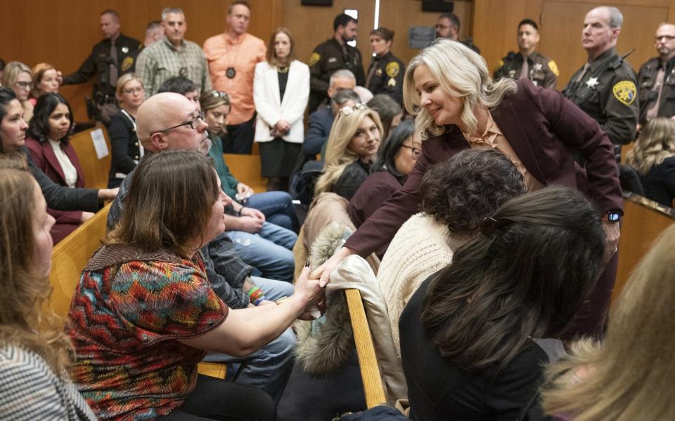 Prosecutor Karen McDonald, right, shakes hands with victims' parents after Jennifer Crumbley was found guilty on four counts of involuntary manslaughter