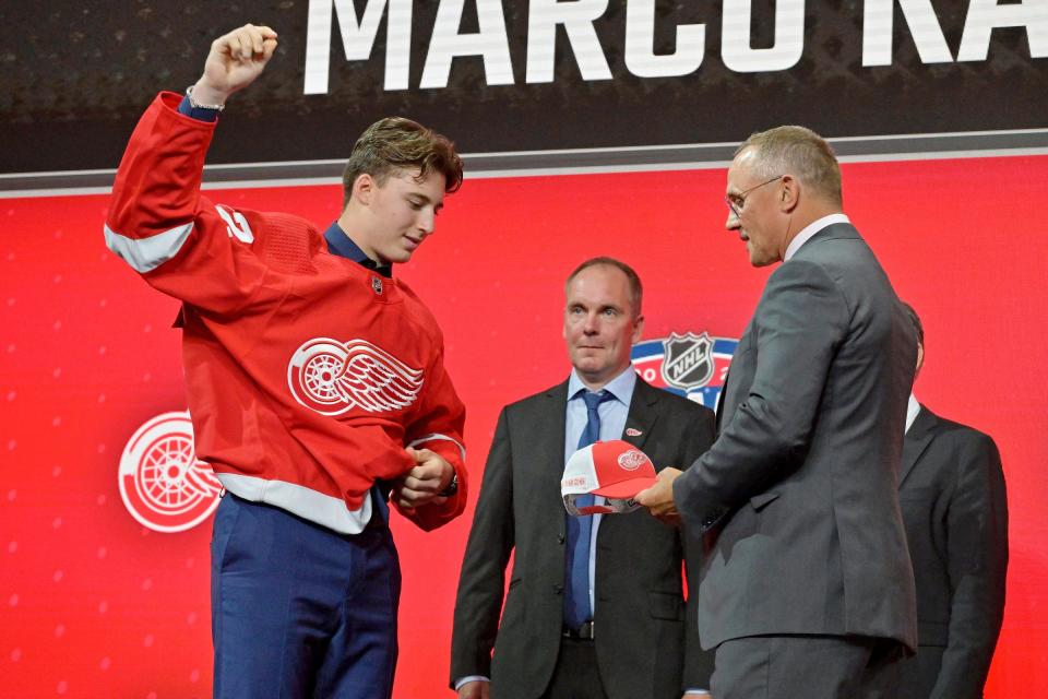 Marco Kasper, the No. 8 overall pick by the Detroit Red Wings on Thursday, July 7, 2022, takes a hat from Wings GM Steve Yzerman during the 2022 NHL draft at Bell Centre in Montreal.