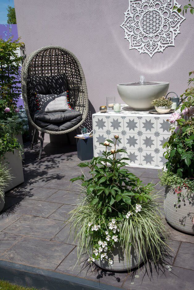 <p>An egg chair takes centre stage at the Mandala, Meditation and Mindfulness Garden. Inspired by conditions imposed by the pandemic, this container garden has been created to offer a safe haven from the world around us. Expect to find buzzing bees, running water and a muted violet wall with a mandala. </p>