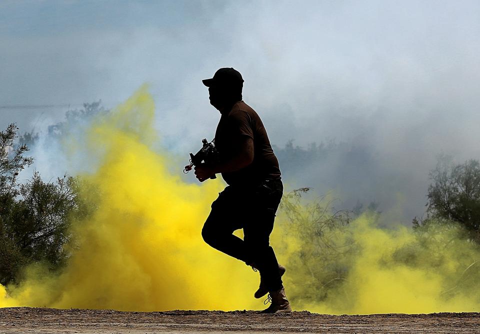 An Iraqi soldier runs while Australian and New Zealand coalition forces participate in a training mission with Iraqi army soldiers at Taji Base, north of Baghdad, Iraq, Wednesday, April 17, 2019. A month after the defeat of the Islamic State group in Syria and Iraq, the U.S.-led international coalition has turned its attention to training Iraqi forces to secure the country against lingering threats posed by IS cells operating in the countryside. (AP Photo/Hadi Mizban)