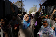 Kashmiri women shout pro freedom slogans during the funeral of Umer Farooq, a Kashmiri civilian who was killed Sunday at Baroosa village 34 Kilometers (21 miles) northeast of Srinagar, Indian controlled Kashmir, Monday, April 10, 2017. Government forces opened fire on Sunday on crowds of people who attacked polling stations during a by-election for a vacant seat in India's Parliament, killing eight people. (AP Photo/Mukhtar Khan)