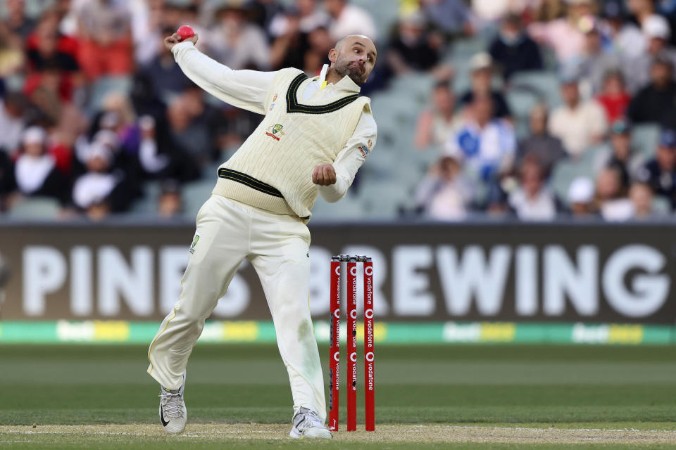 FILE- Australia's Nathan Lyon bowls during the fourth day of the Ashes cricket test match against England in Adelaide, Australia, Sunday, Dec. 19, 2021. Lyon's quest for his 500th test wicket will be one of the individual features of the first cricket test between Australia and Pakistan at Perth Stadium starting Thursday, Dec. 14, 2023. (AP Photo/James Elsby,File)