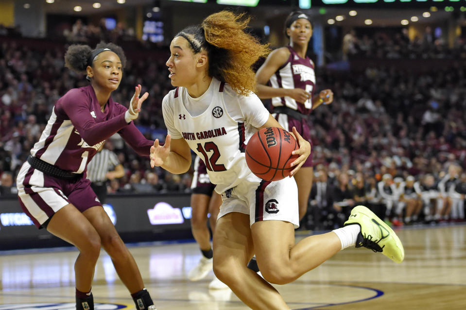 FILE - In this March 8, 2020, file photo, South Carolina's Brea Beal (12) drives while defended by Mississippi State's Myah Taylor (1) during a championship match at the Southeastern Conference women's NCAA college basketball tournament in Greenville, S.C. South Carolina is ranked No. 1 in the women's NCAA college basketball poll released Tuesday, Nov. 10, 2020.(AP Photo/Richard Shiro, File)
