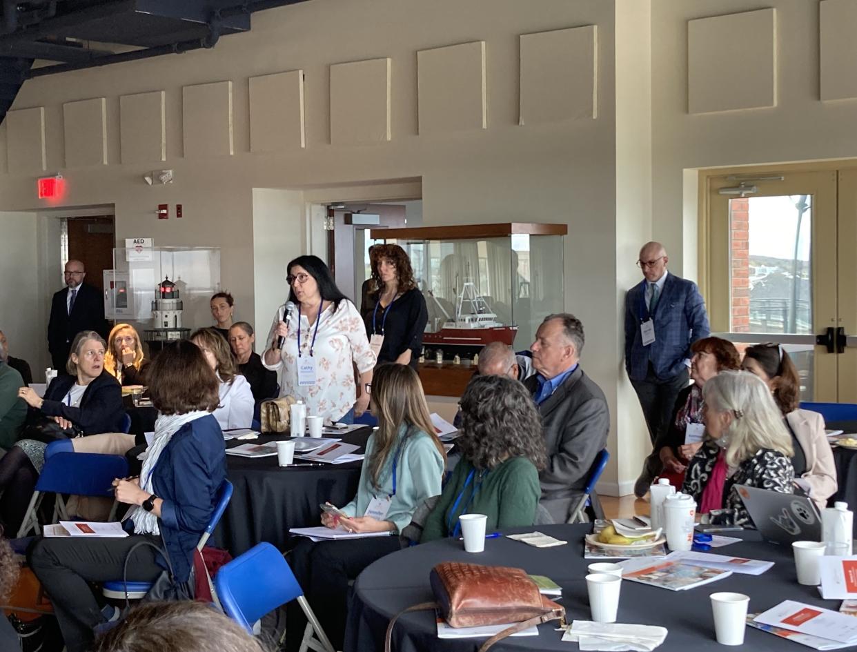 Fairhaven's Cathy Melanson asks a question at Tuesday's regional housing summit hosted by the Regeneration Project.