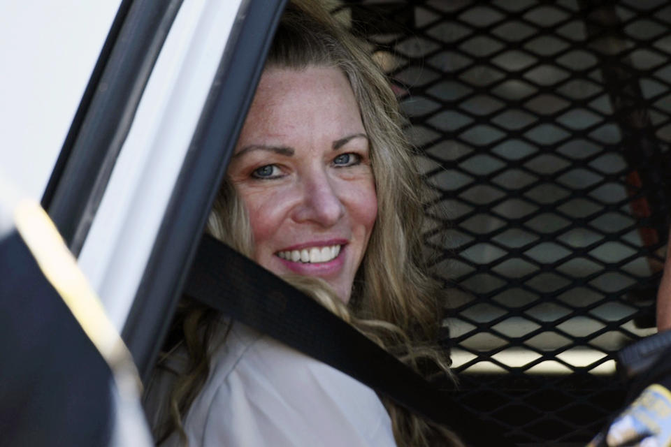 FILE - Lori Vallow Daybell sits in a police car after a hearing at the Fremont County Courthouse in St. Anthony, Idaho, on Aug. 16, 2022. The sister of Tammy Daybell, who was killed in what prosecutors say was a doomsday-focused plot, told jurors Friday, April 28, 2023, that her sister's funeral was held so quickly that some family members couldn't attend. The testimony came in the triple murder trial of Vallow Daybell, who is accused along with Chad Daybell in Tammy's death and the deaths of Vallow Daybell's two youngest children. (Tony Blakeslee/East Idaho News via AP, Pool, File)