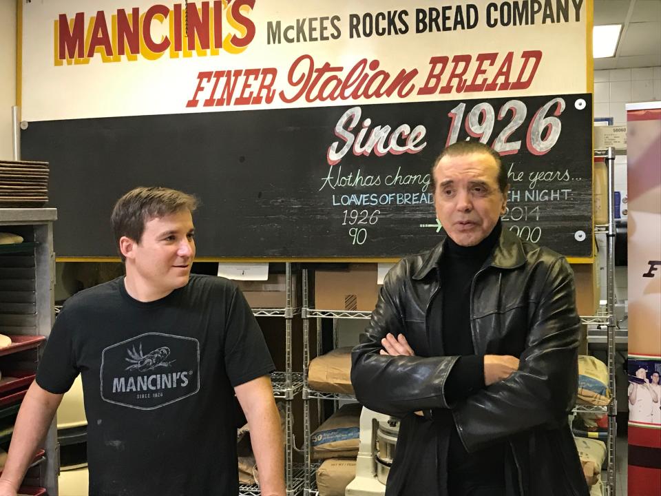 Famed actor Chazz Palminteri, right, learned to bake the Mancini Twist on a recent promotional stop in Pittsburgh at the Mancini Bread Co. bakery in the Strip District. Palminiteri came to town to talk about his musical, “A Bronx Tale,” appearing next month at the Benedum Center. [Scott Tady/BCT Staff]