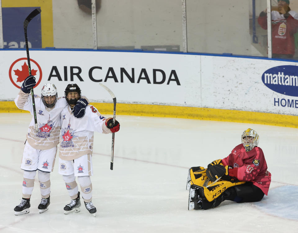 TORONTO, ON- JANUARY 29  - Team World FANNI GASPARICS (94) and Team World LEAH LUM (8) celebrate after scoring on Team Canada CORINNE SCHROEDER (30) as members of the Premier Hockey Federation (PHF) All-Stars play in their All-Star Game  at Mattamy Athletic Centre in Toronto. January 29, 2023.        (Steve Russell/Toronto Star via Getty Images)