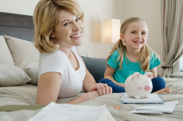 BM7Y94 Mother and daughter saving money  Motherdaughtersavingmoney; Saving; money18-19; years20-25; years5-6; yearsChild