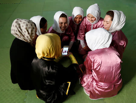 Students of the Shaolin Wushu club chat before an exercise in Kabul, Afghanistan January 19, 2017. REUTERS/Mohammad Ismail