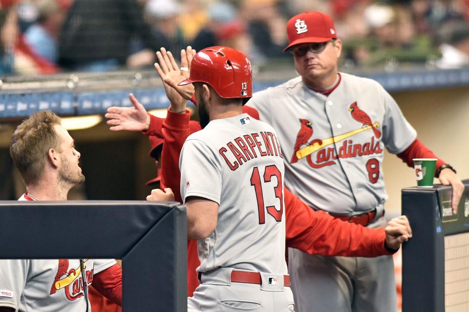 Matt Carpenter is greeted by Cardinals manager Mike Shildt (right) and teammates after smacking a homer off Brewers starter Corbin Burnes in 2019.