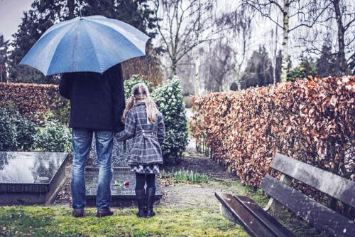 father and child in cemetery