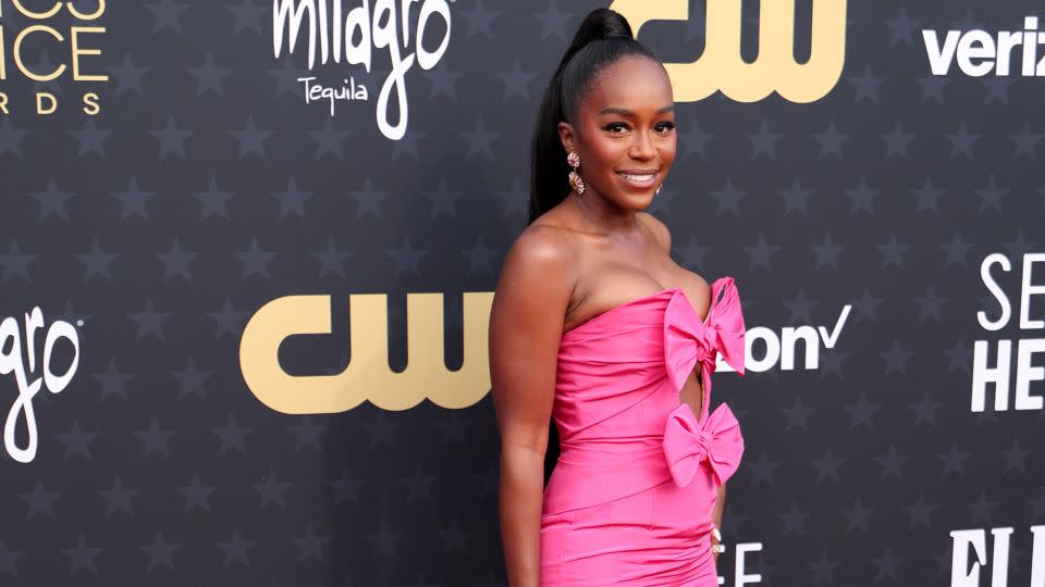 “Lessons in Chemistry” actress Aja Naomi King in a bright pink Oscar de la Renta mermaid gown with oversized pink bow accents and cut-out bodice. - Christopher Polk/WWD/Getty Images