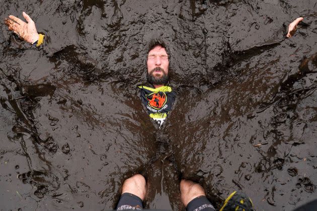 A competitor drops into mud during a Tough Mudder event at Cholmondeley Castle Gardens in Cheshire, England, on Sept. 4. (Photo: Jacob King/PA via AP)