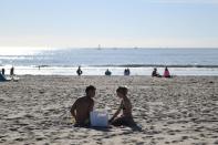 People visit the beach a day before renewed restrictions due to a surge of coronavirus disease (COVID-19) cases in Los Angeles