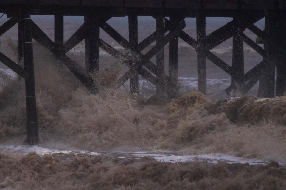 Waves turned mud brown by storm runoff water hit a pier as the second and more powerful of two atmospheric river storms, and potentially the biggest storm of the season, arrives to Santa Barbara, California, on February 4, 2024. The US West Coast was getting drenched on February 1 as the first of two powerful storms moved in, part of a u0022Pineapple Expressu0022 weather pattern that was washing out roads and sparking flood warnings. The National Weather Service said u0022the largest storm of the seasonu0022 would likely begin on February 4.