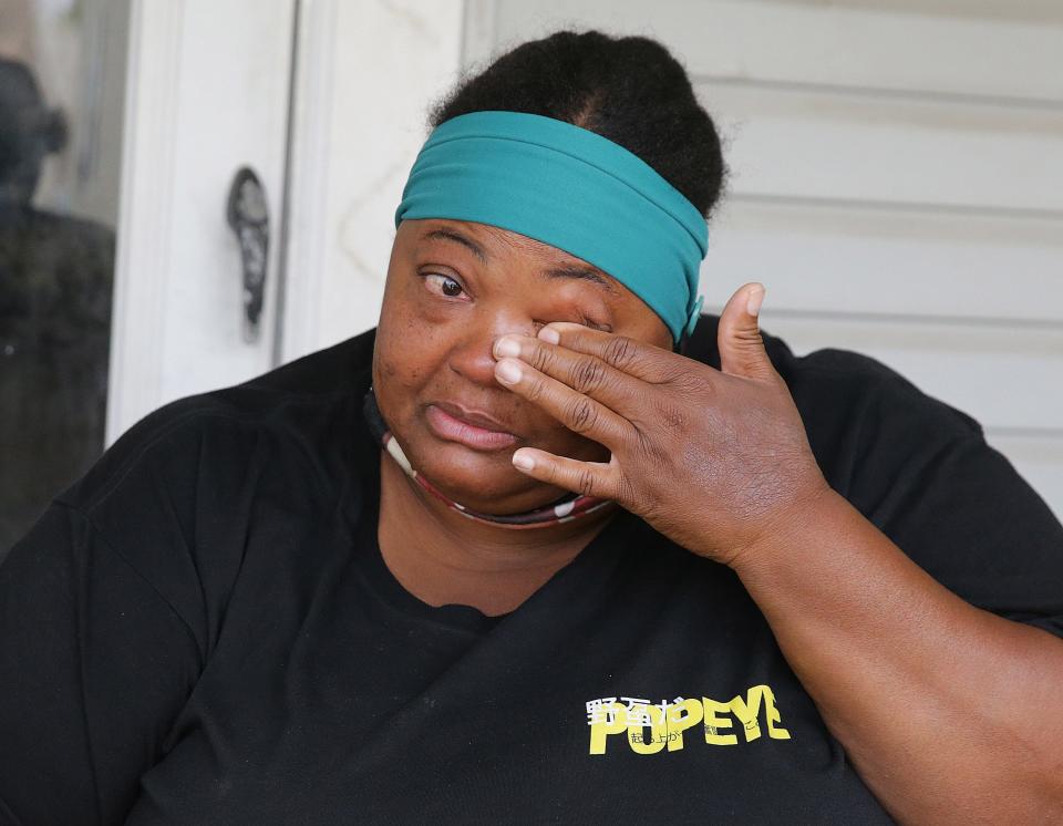 Vinesa Glenn wipes a tear while talking about her dog Brownie who was shot and killed by a police officer last week.