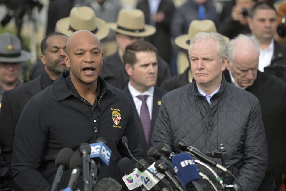 Maryland Gov. Wes Moore, left, speaks during a news conference as Sen. Chris Van Hollen (D-MD) looks on near the scene where a container ship collided with a support on the Francis Scott Key Bridge, Tuesday, March 26, 2024 in Baltimore. The major bridge in Baltimore snapped and collapsed after a container ship rammed into it early Tuesday, and several vehicles fell into the river below. Rescuers were searching for multiple people in the water. (AP Photo/Steve Ruark)