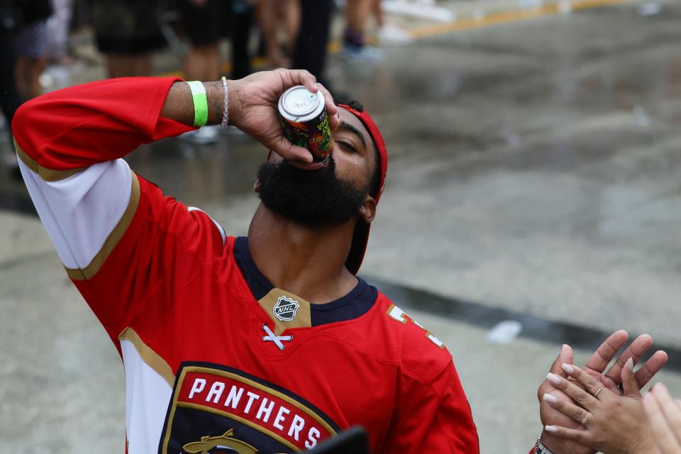 Dolphins running back Raheem Mostert drinks a beer during the Florida Panthers' Stanley Cup victory parade in Fort Lauderdale in June.