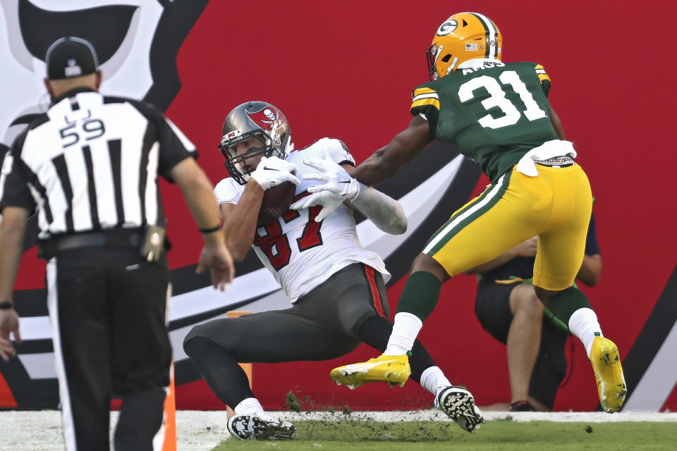 Tampa Bay Buccaneers tight end Rob Gronkowski (87) makes a 12-yard touchdown catch in front of Green Bay Packers strong safety Adrian Amos (31) during the first half of an NFL football game Sunday, Oct. 18, 2020, in Tampa, Fla. (AP Photo/Mark LoMoglio)