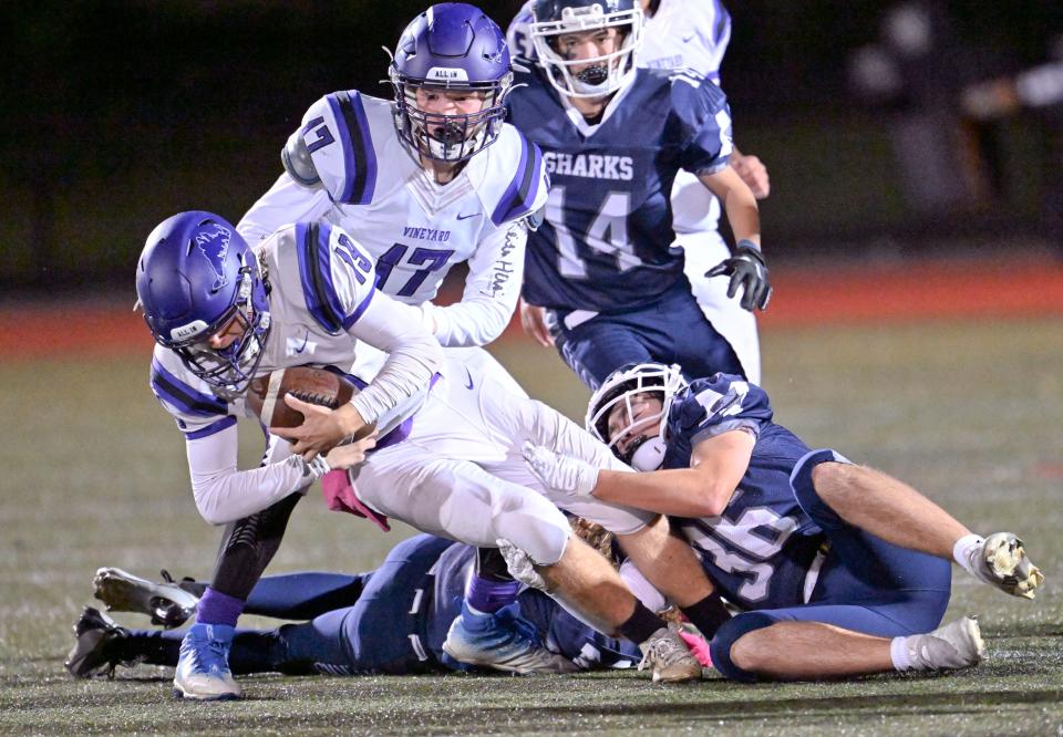 Aiden Conley of Martha's Vineyard is brought down by Maxton Furman of Monomoy.