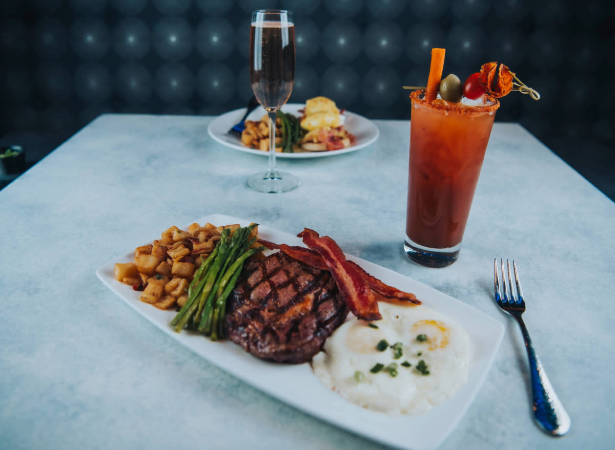 kona grill brunch spread with steak, asparagus, potatoes, bacon, and a bloody mary