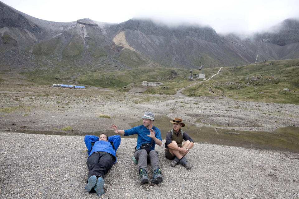 In this Saturday, Aug. 18, 2018, photo, Tarjei Naess Skrede of Norway, center, gestures near Jo of Norway, left, and Paula of Australia, right, while resting on the banks of Lake Chon during a hike arranged by Roger Shepherd of Hike Korea on Mount Paektu in North Korea. Hoping to open up a side of North Korea rarely seen by outsiders, Shepherd, a New Zealander who has extensive experience climbing the mountains of North and South Korea is leading the first group of foreign tourists allowed to trek off road and camp out under the stars on Mount Paektu, a huge volcano that straddles the border that separates China and North Korea. (AP Photo/Ng Han Guan)