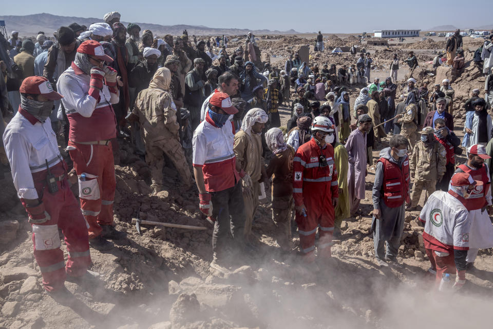 Iranian rescue team and Afghan men search for victims after an earthquake in Zenda Jan district in Herat province, of western Afghanistan, Monday, Oct. 9, 2023. Saturday's deadly earthquake killed and injured thousands when it leveled an untold number of homes in Herat province. (AP Photo/Ebrahim Noroozi)