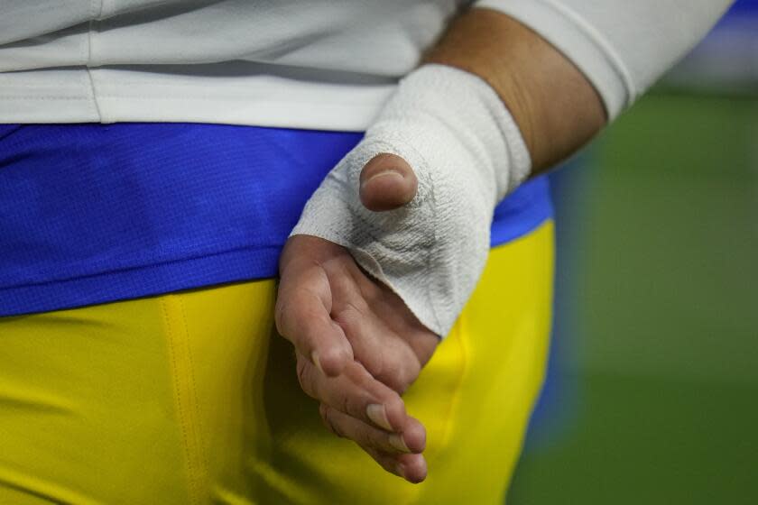 Los Angeles Rams quarterback Matthew Stafford wears a bandage on his throwing hand during the second half of an NFL football game against the Dallas Cowboys Sunday, Oct. 29, 2023, in Arlington, Texas. (AP Photo/Julio Cortez)