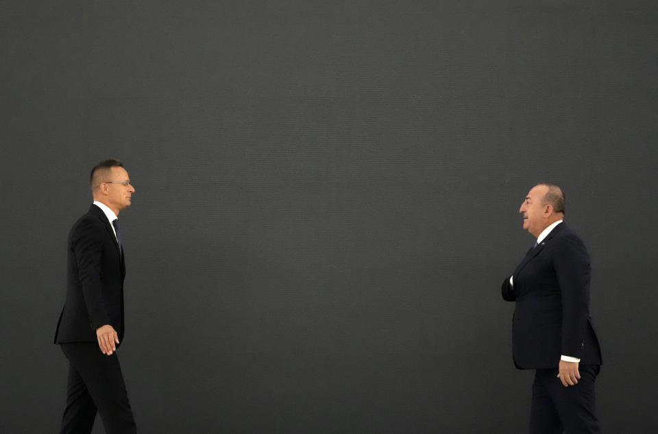 Turkey's Foreign Minister Mevlut Cavusoglu, right, speaks with Hungarian Foreign Minister Peter Szijjarto before the "Open Balkan" economic forum for regional cooperation in Belgrade, Serbia, Friday, Sept. 2, 2022. (AP Photo/Darko Vojinovic)