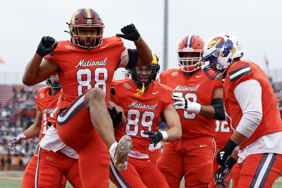 National tight end Brevyn Spann-Ford of Minnesota (88) celebrates with teammates after scoring a touchdown against the American team during the first half of the Senior Bowl NCAA college football game, Saturday, Feb. 3, 2024, in Mobile, Ala. (AP Photo/ Butch Dill)