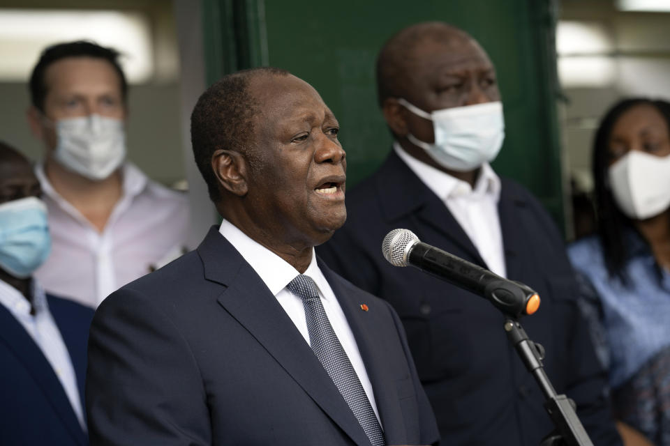 Ivory Coast President Alassane Ouattara speaks to journalists after voting at a polling station during presidential elections in Abidjan, Ivory Coast, Saturday, Oct. 31, 2020. Tens of thousands of security forces deployed across Ivory Coast on Saturday as the leading opposition parties boycotted the election, calling President Ouattara's bid for a third term illegal. (AP Photo/Leo Correa)