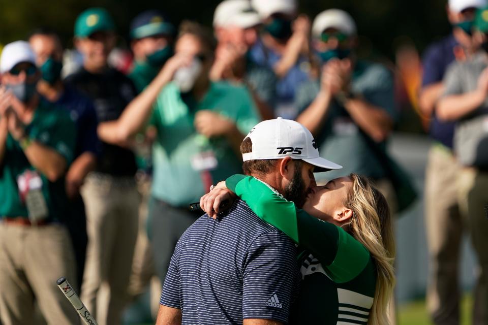 Dustin Johnson gets a kiss from Paulina Gretzky after winning The Masters in 2020, his second victory in one of golf's four majors.