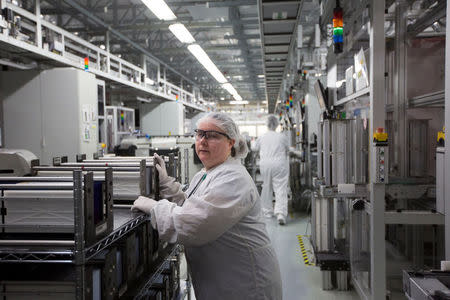 Production operator Wendy Love, pushes a cart laden with cells at the SolarWorld solar panel factory in Hillsboro, Oregon, U.S., January 15, 2018. Picture taken January 15, 2018. REUTERS/Natalie Behring