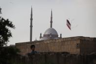 <b>CAIRO, EGYPT:</b> A boy flies a kite in sight of the mosque of Muhammad Ali Pasha on The Citadel of Cairo. This mosque, along with the citadel, is one of the landmarks and tourist attractions of Cairo and is one of the first features to be seen when approaching the city. The mosque was built by Muhammad Ali Pasha, an Albanian commander in the Ottoman army largely considered the founder of modern Egypt, in memory of Tusun Pasha, his oldest son, who died in 1816.