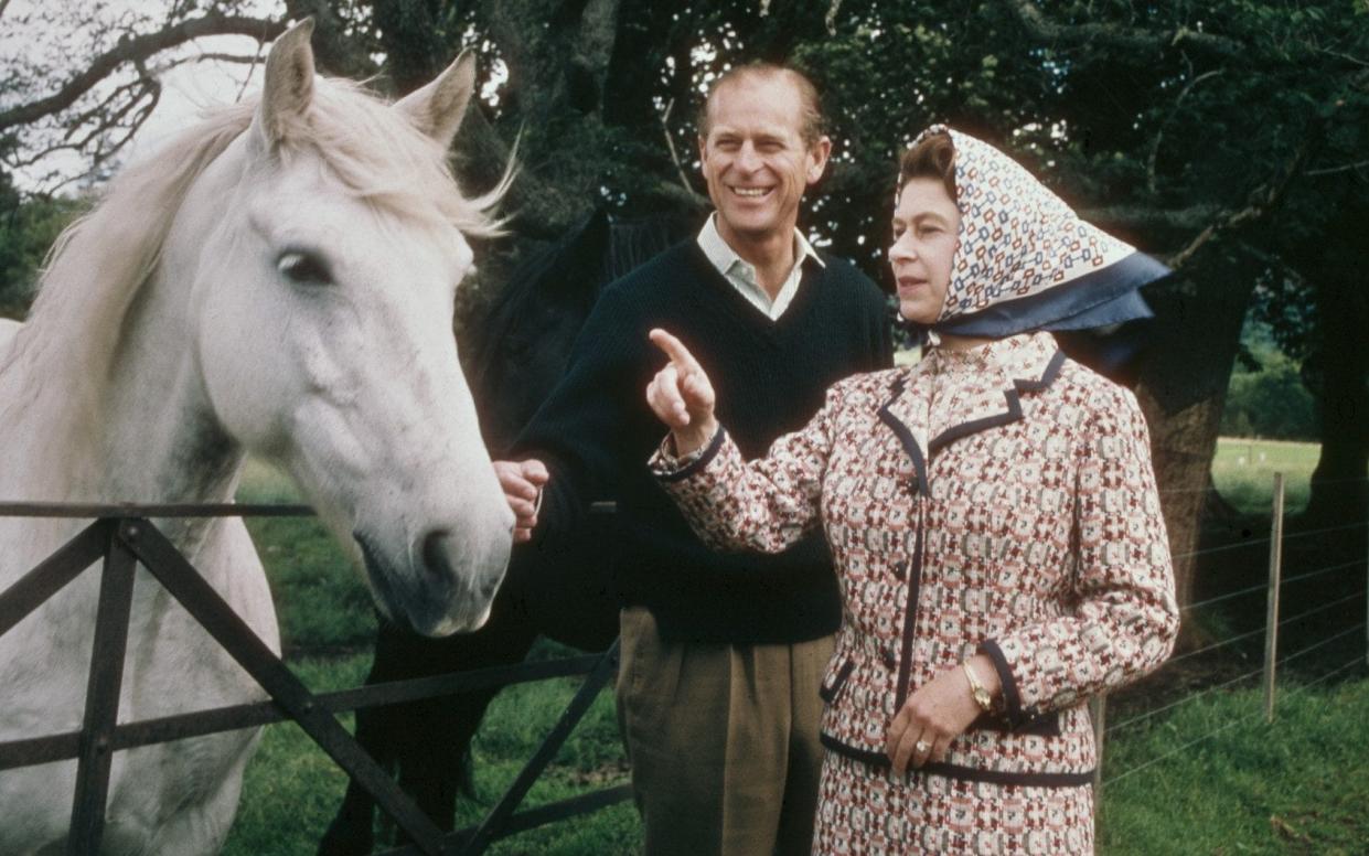 The late Queen, pictured here with Prince Philip at Balmoral in 1972, was fond of wearing a silk scarf as a head covering