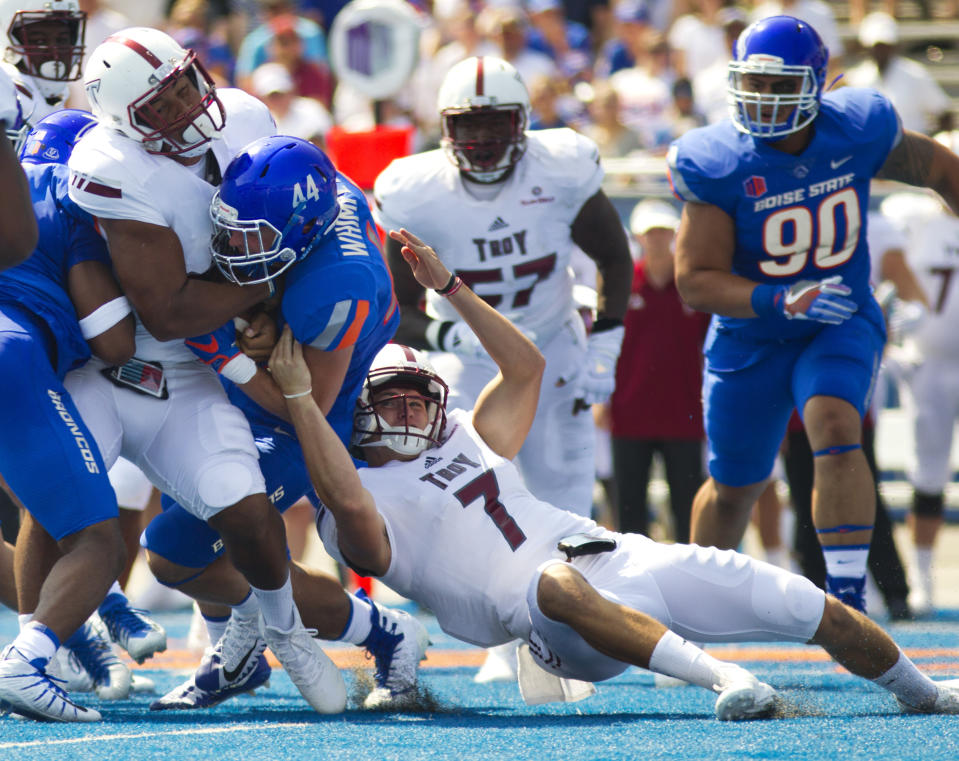 Troy running back Josh Anderson (33) is stopped at the line of scrimmage by Boise State safety Jace Richter (44) before Troy quarterback Kaleb Barker (7) can let go of the ball during an NCAA college football game Saturday, Sept. 2, 2017, in Boise. (Pat Sutphin/The Times-News via AP)