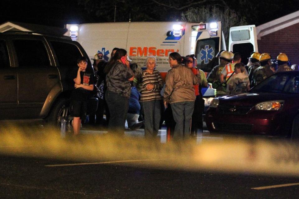 Members of Freedom Baptist Church near Laurel, Miss. gather outside the Family Life Center following a second floor collapse that injured up to 35 youths during Wednesday night services Feb. 19, 2014. A 16-year-old girl who suffered a head injury was airlifted to Forrest General Hospital in Hattiesburg. (AP Photo/The Chronicle, James Pugh)