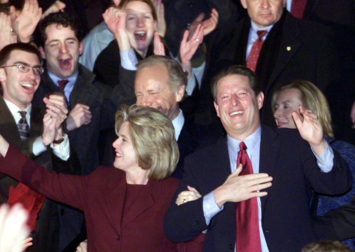 Al and Tipper Gore, arm in arm, stand amid smiling, applauding supporters