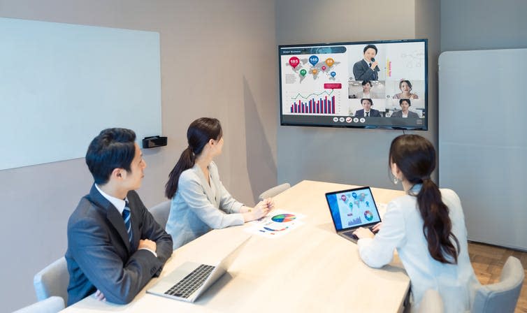 Chinese people having Zoom conference in office