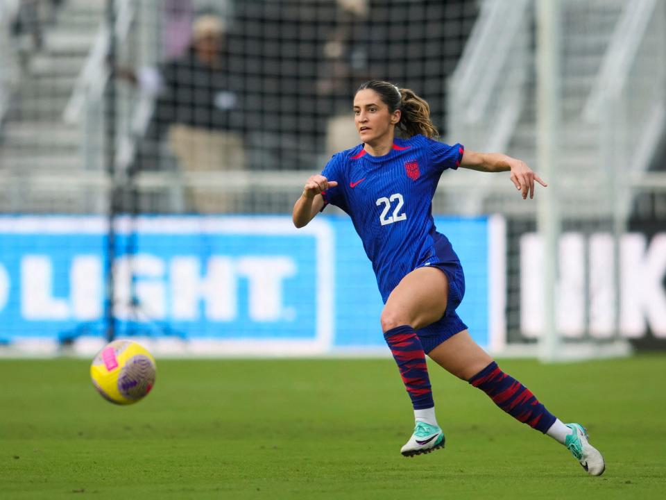Savannah DeMelo dribbles the ball for the USWNT.