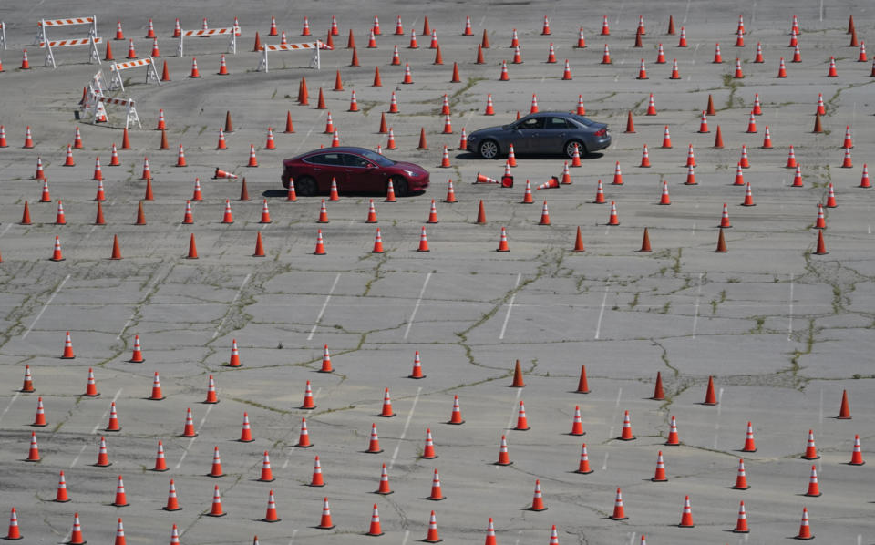 Vehicles drive around in opposite directions in a maze of traffic cones, as they enter the Dodgers Stadium vaccination site in Los Angeles Friday, April 2, 2021. California has administered nearly 19 million doses, and nearly 6.9 million people are fully vaccinated in a state with almost 40 million residents. But only people 50 and over are eligible statewide to get the vaccine now. Adults 16 and older won't be eligible until April 15. (AP Photo/Damian Dovarganes)