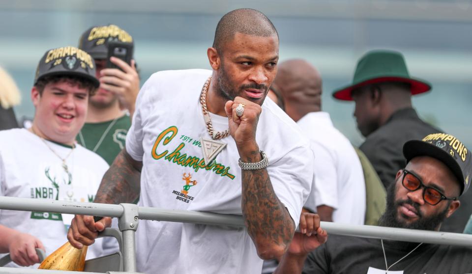 Milwaukee Bucks forward P.J. Tucker holds up a fist as the crowd cheers during the Milwaukee Bucks' NBA Championship parade on Thursday, July 22, 2021, in Milwaukee.