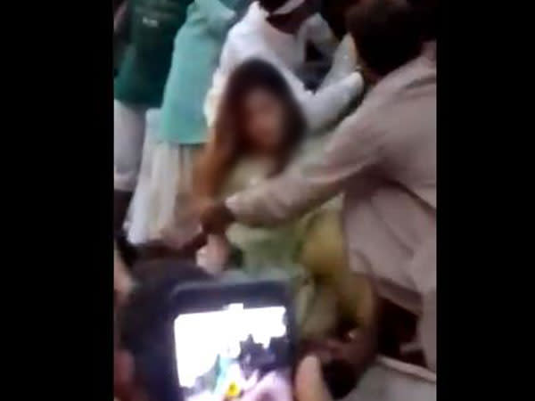 A visual of a mob of men attacking a woman in Pakistan (Photo credit: Twitter@qiranbutt)
