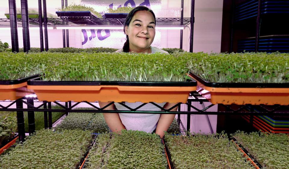 Jessica Hicks with her microgreens at her home Saturday June 18, 2022.