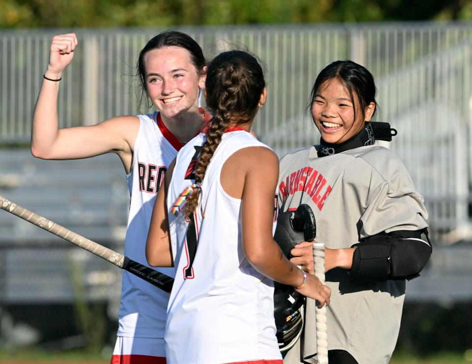 Sam Marczely (left) and Caitlin Ward celebrate with goalie Barnstable goalie Meili Raspante after beating D-Y 5-1.
