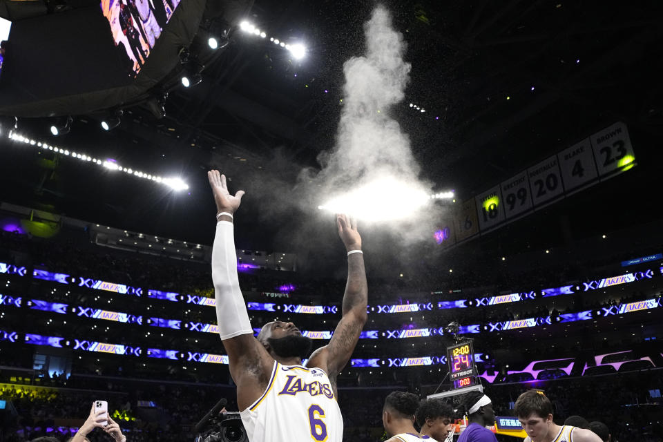 Los Angeles Lakers forward LeBron James tosses powder in the air prior to Game 3 of an NBA basketball Western Conference semifinal against the Golden State Warriors Saturday, May 6, 2023, in Los Angeles. (AP Photo/Mark J. Terrill)